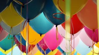 close up of blue, orange, pink and yellow balloons